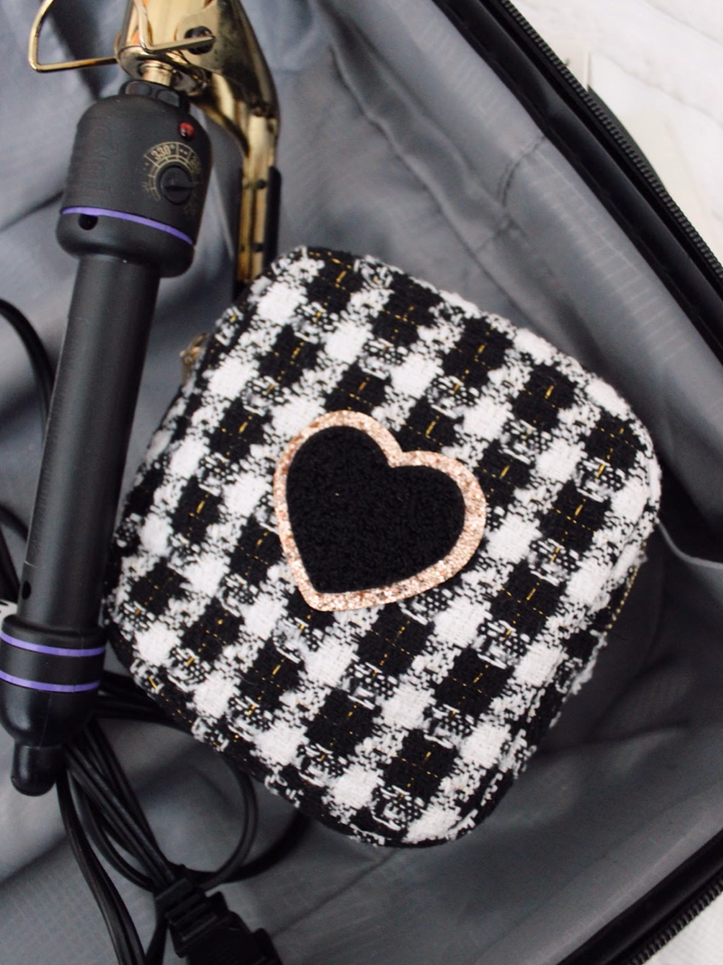 Picture of a mini size black and white plaid tweed zippered bag with heart shaped chenille patch