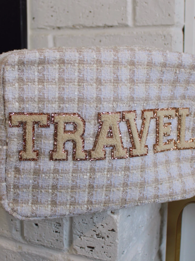 Picture of tan white plaid tweed bag with chenille patches spelling out TRAVEL 